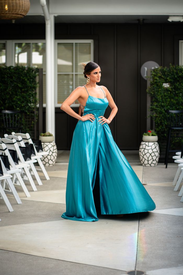 digital-01 Woman in a stunning blue dress posing gracefully at an outdoor event. Perfect for fashion themes.